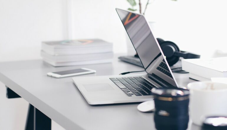 A laptop and phone on a desk