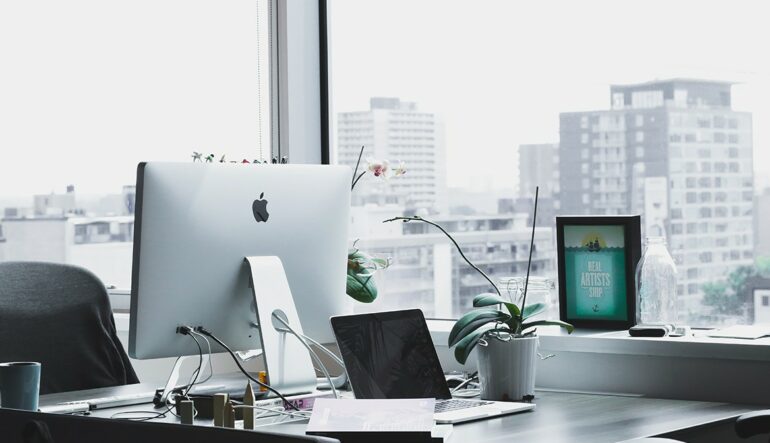 An office desk beside a big window